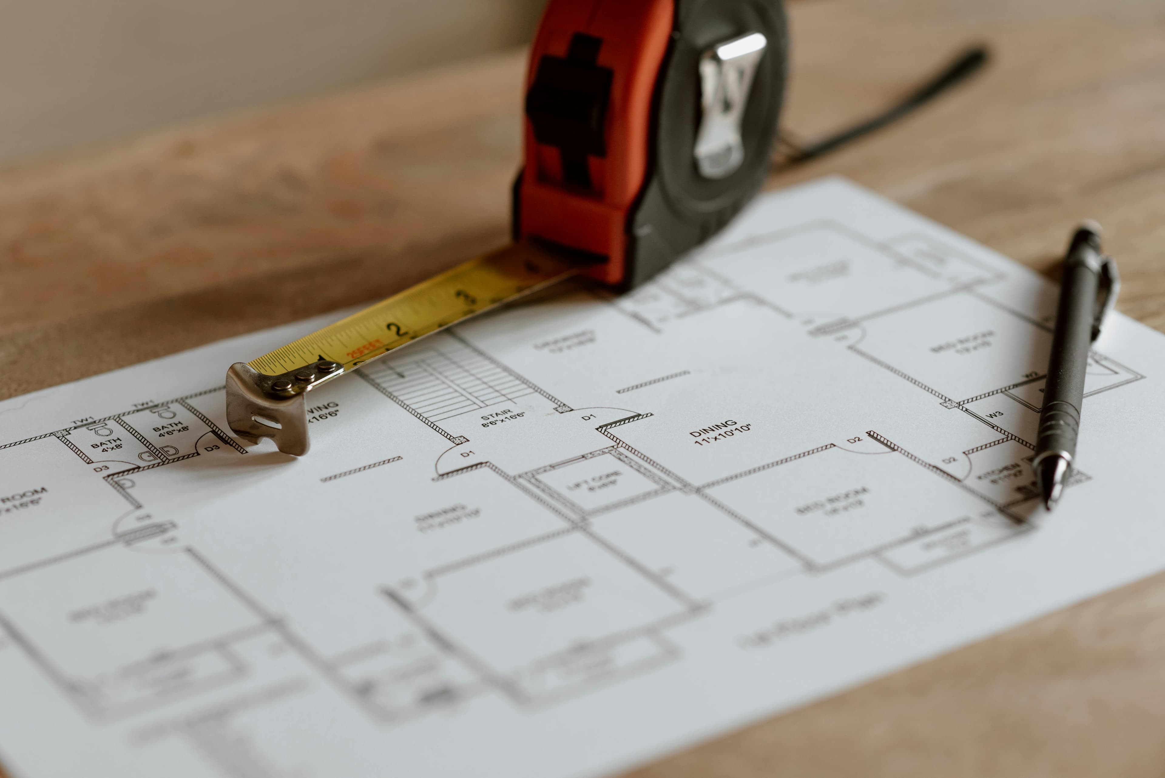 Construction plans and tape measure on a work table